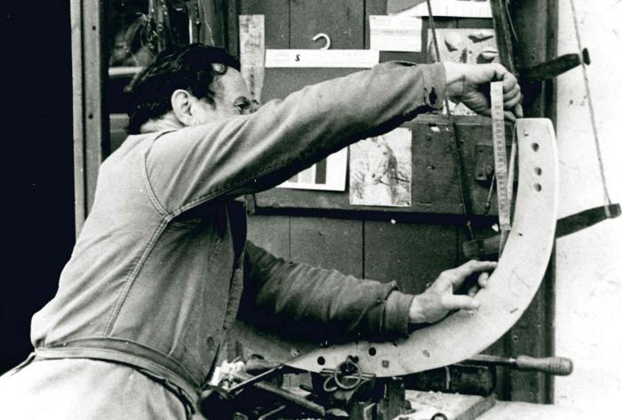 Jean Ros fabriquant un bât : mesure d'un arceau en hêtre.